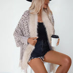 womens shawl layered with denim shorts and top, combining leopard print and warmth for modern winter style