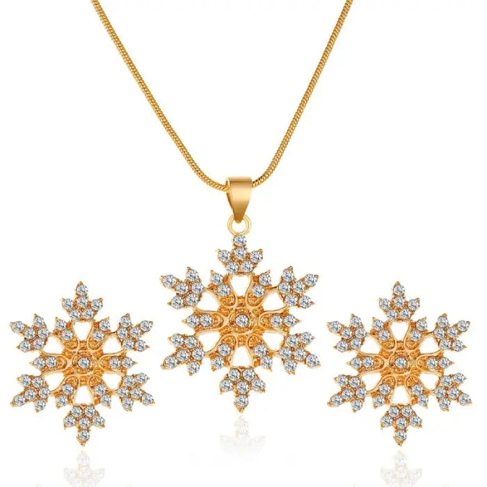 Women’s snowflake necklace and earring set in gold with crystal snowflake pendant and matching earrings shown in bright detailed product view