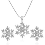 Women’s snowflake necklace and earring set in silver with sparkling crystal snowflake pendant and matching studs displayed in elegant detail