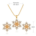 Women’s snowflake necklace and earring set in gold shown with size measurements, highlighting crystal snowflake pendant and matching studs