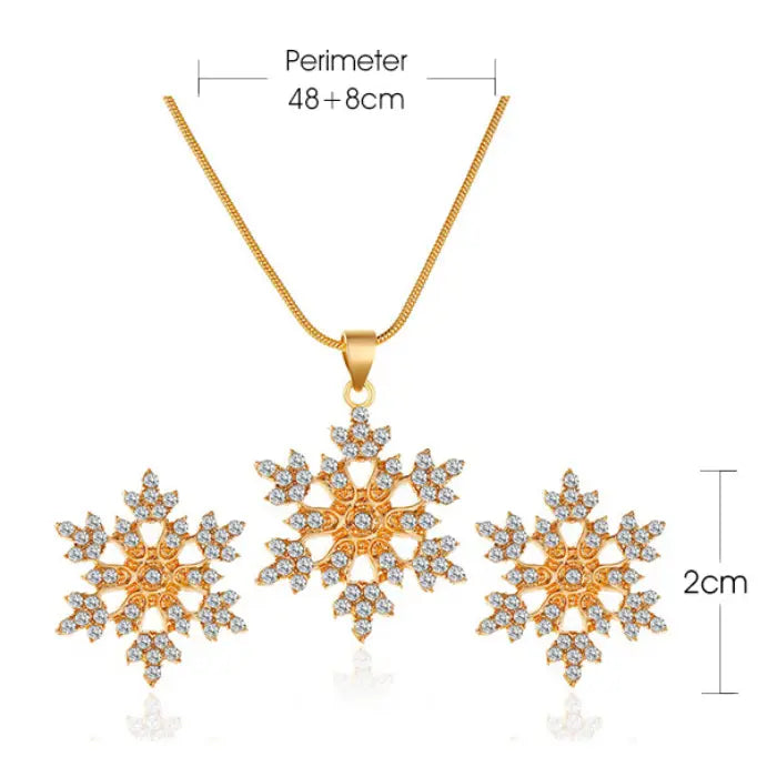 Women’s snowflake necklace and earring set in gold shown with size measurements, highlighting crystal snowflake pendant and matching studs