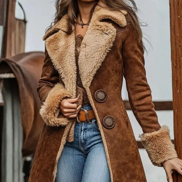 Person wearing a brown shearling coat with a blurred background