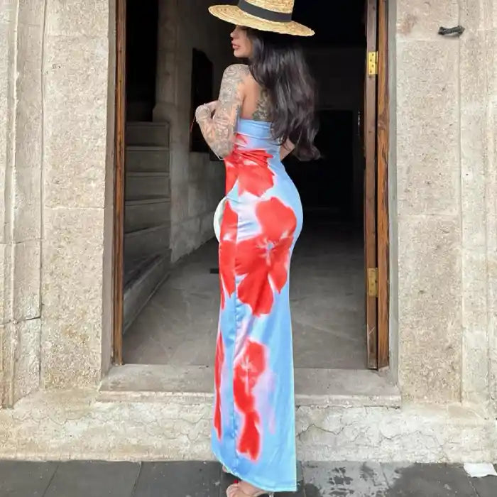 Blue summer slit dress with bold red floral patterns styled with a straw hat