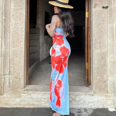 Blue summer slit dress with bold red floral patterns styled with a straw hat