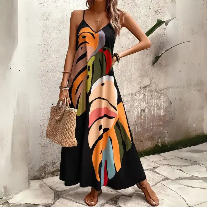 Women's tropical leaf print maxi dress in black with multicolor abstract leaves and V-neckline.