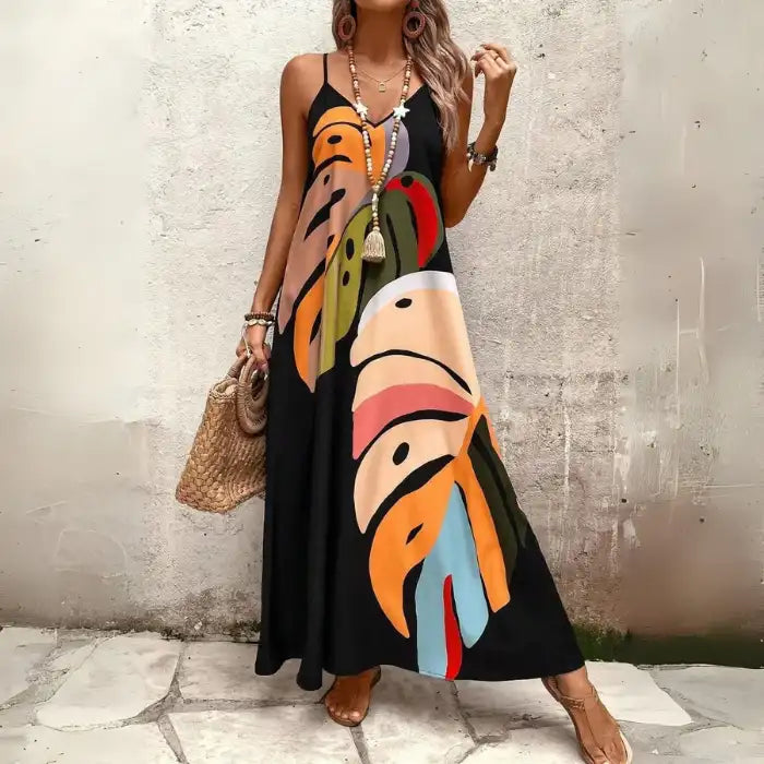  Women's tropical leaf print maxi dress styled with boho jewelry, beach bag, and flat sandals.