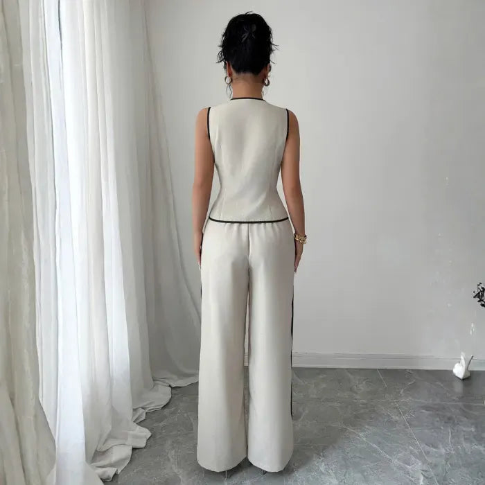 womens vest pant set shown from back with ivory tailored vest and wide leg pants featuring contrast trim for sleek fit