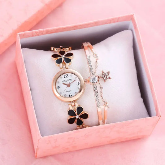 Women's watch bracelet set with black flower design in a pink gift box.