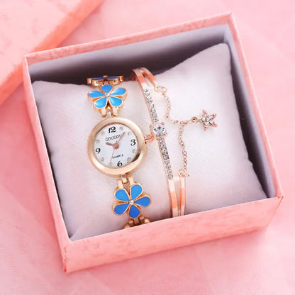 Women's watch bracelet set with blue flower design in a pink gift box.