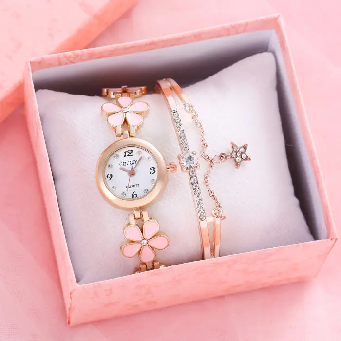 Women's watch bracelet set with pink flower design and crystal bracelet in a pink gift box.