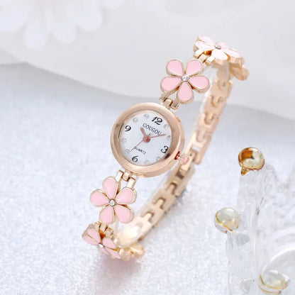 Women's watch bracelet set with pink flower design and rose gold accents.