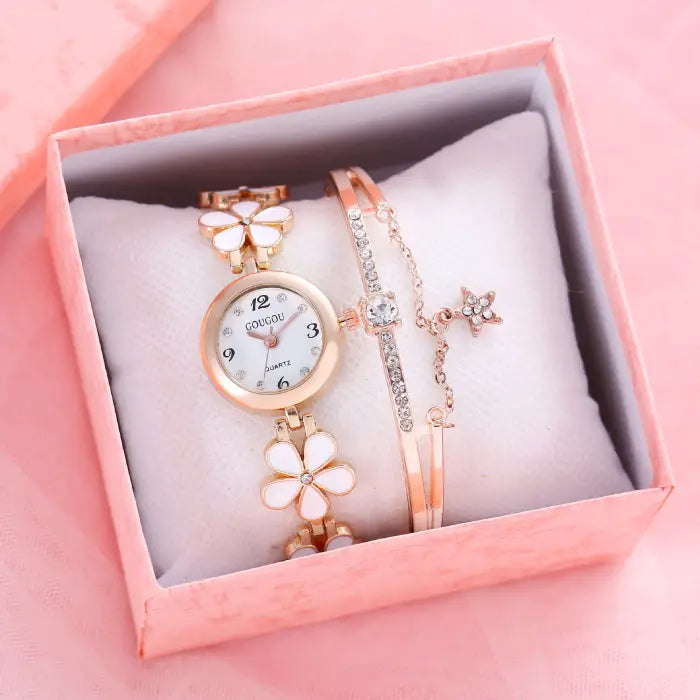 Women's watch bracelet set with white flower design and crystal bracelet in a pink gift box.