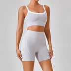 Women's workout set in heather gray featuring sports bra and high-waisted shorts with white contrast trim and contour lines