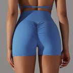 Womens yoga shorts in sky blue with scrunch glute design and seamless waistband for comfort and shape.