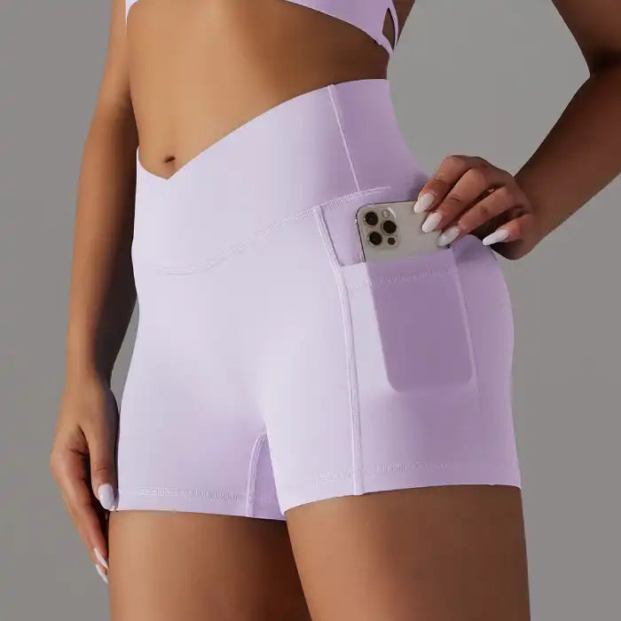 Womens yoga shorts in lavender with high waist and side pocket, perfect for studio and street wear.