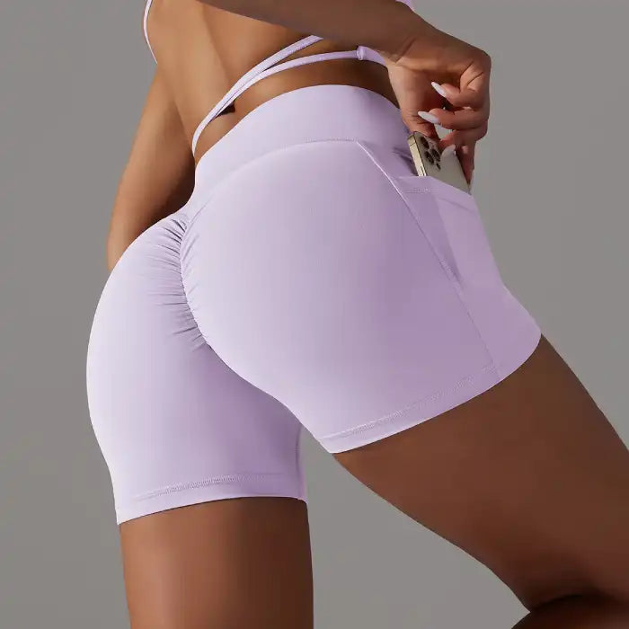Womens yoga shorts in light purple with scrunch back and phone pocket, sculpting fit for active women