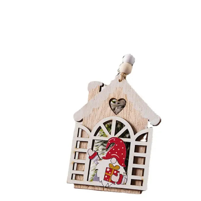 Close-up of Wooden Christmas Ornament shaped like a house with a red gnome holding a gift