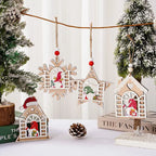 Wooden Christmas Ornaments with gnome window designs hanging from twine on a snow-dusted tree