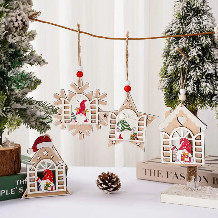 Wooden Christmas Ornaments with gnome window designs hanging from twine on a snow-dusted tree