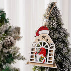 Wooden Christmas Ornament shaped like a house with a gnome and Santa hat detail on a snowy tree