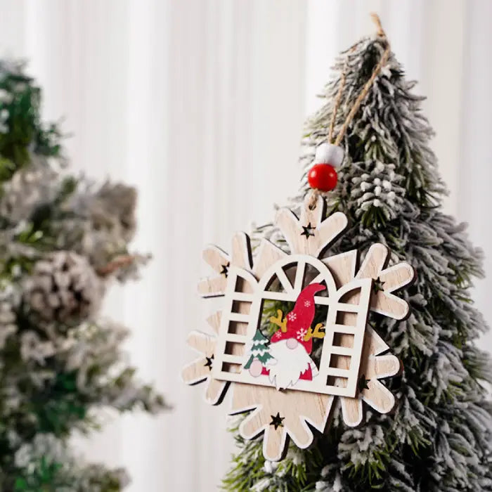 Snowflake-shaped Wooden Christmas Ornament with a red gnome and reindeer antlers on pine tree