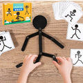 Wooden stick figure toy with pose cards and packaging displayed on a wooden table.
