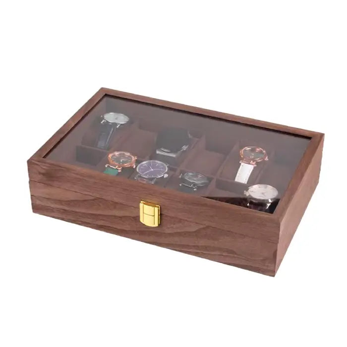 Top view of an open wooden watch display case showcasing various watches in separate compartments