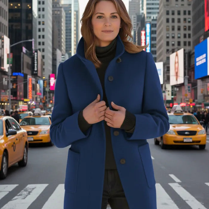 Wool pea coat in navy worn by a woman in a city scene with yellow taxis.