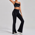 Workout clothes women featuring black sports bra with high-waisted flared pants and white contour piping for stylish fitness wear