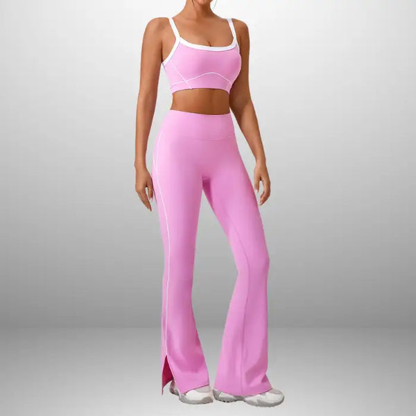Workout clothes women in bright pink featuring sports bra and high-waisted flared pants with white trim and side slit detail