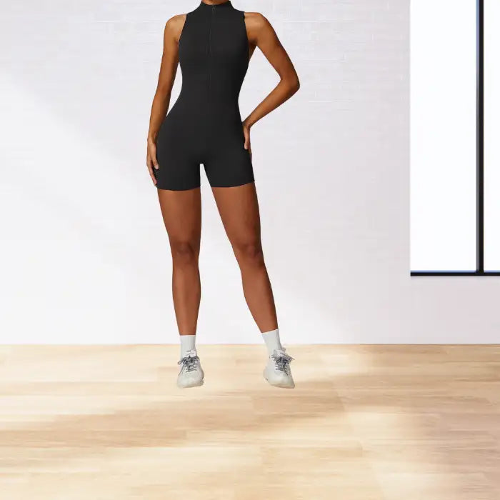 workout romper in classic black with mock neck and front zip closure showcased against minimalist studio background