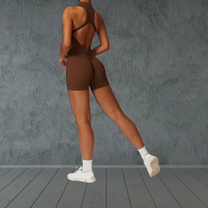 workout romper in rich brown with open back design featuring stylish ruched detail for enhanced comfort during exercise