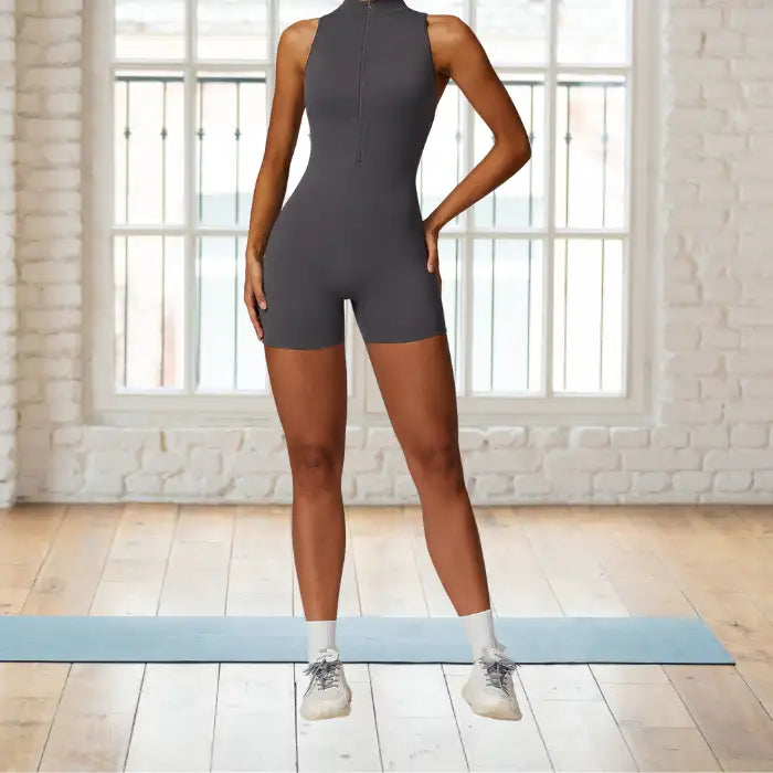 workout romper in charcoal gray featuring sleek front zipper design perfect for high-intensity training in studio settings