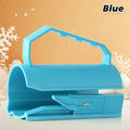 Wrapping paper cutter in bright blue with ergonomic handle shown on festive winter background.