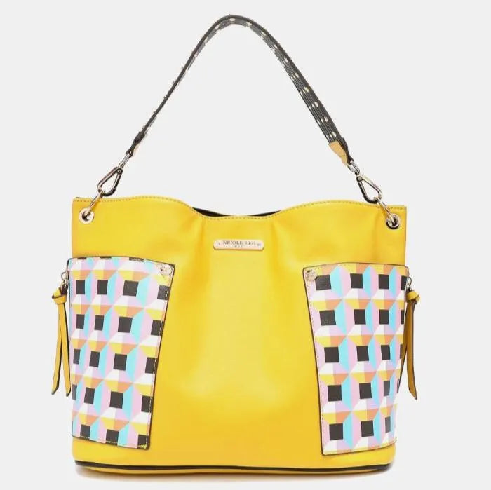 Yellow leather handbag with geometric pattern side panels and studded black strap, featuring modern color-block design