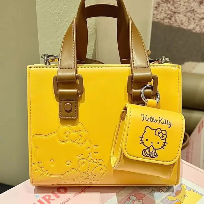 Yellow Hello Kitty handbag with small pouch featuring embossed design and brown straps for daily use.