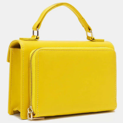 Yellow leather handbag with top handle and side zipper detail, shown from side angle