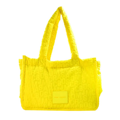 Vibrant yellow Marc Jacobs tote bag showcasing a sleek back design with embossed logo detail.