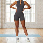 yoga bodysuit in charcoal gray featuring front zip design and sleek athletic fit perfect for movement and flexibility