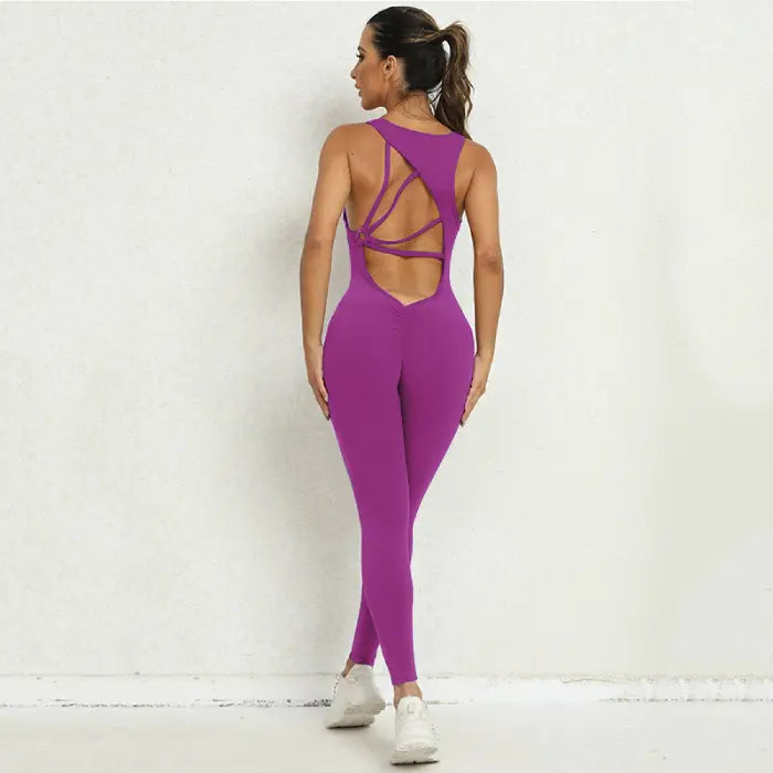 Yoga-jumpsuit in purple with crisscross open back and seamless fit, perfect for flexible motion exercises.