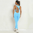 Yoga-jumpsuit in bright blue featuring open crisscross back design and full-length legs for workouts.