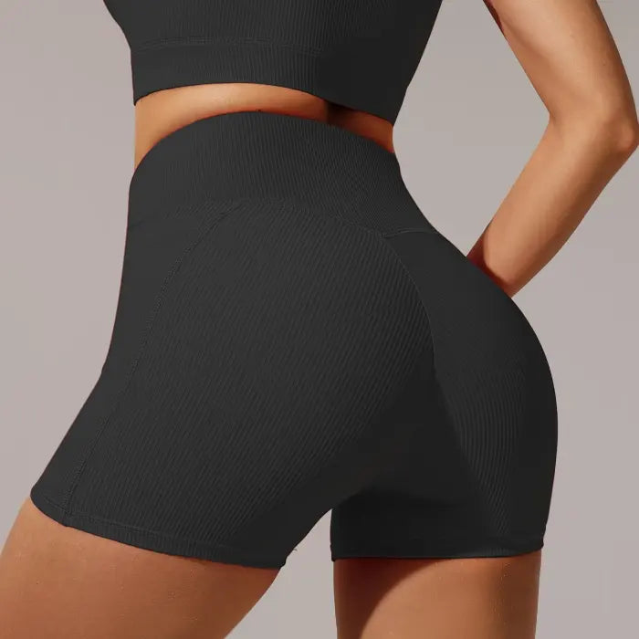 Yoga shorts set in black with ribbed fabric and sculpted back design for athletic fit.