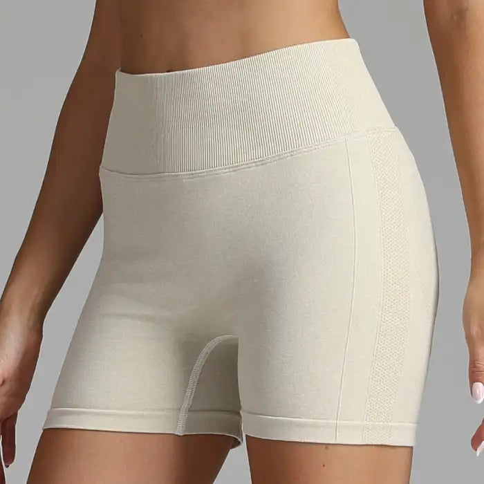 Yoga shorts women in beige tone with textured waistband and stretchy fabric.