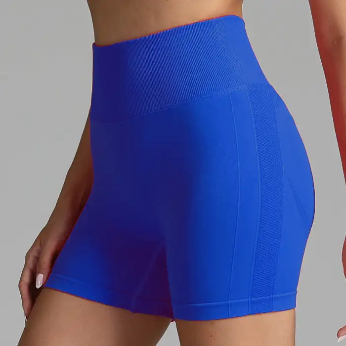 Yoga shorts women in bold royal blue with compression fit and breathable mesh panel.