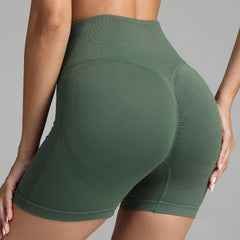 Yoga shorts women green seamless design with peach-lift contouring for gym and activewear.