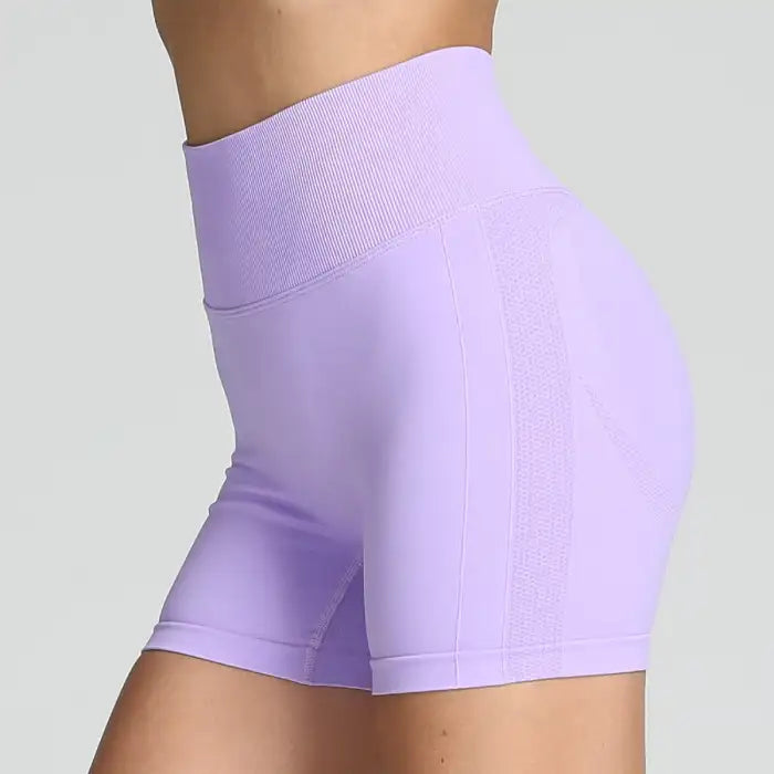 Yoga shorts women in lavender shade featuring sculpted seams and high-rise waistband.