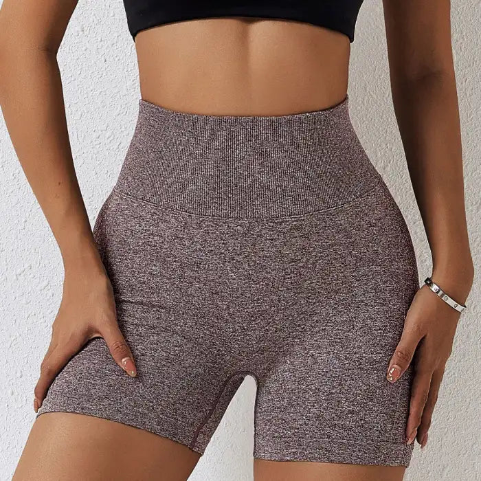 Yoga shorts women in maroon heathered design with supportive ribbed waist and snug fit.