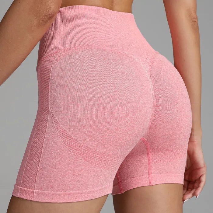 Yoga shorts women pink back view with seamless contour shaping and ribbed high waistband for support.