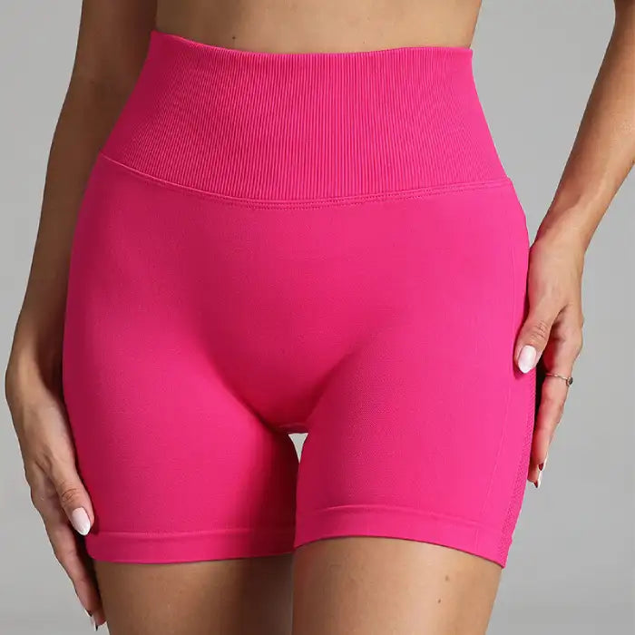 Yoga shorts women in vibrant pink featuring high waistband and smooth front fit.