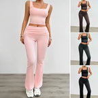 Women's pink yoga two-piece set with a sleeveless crop top and high-waisted flared pants, perfect for workouts.